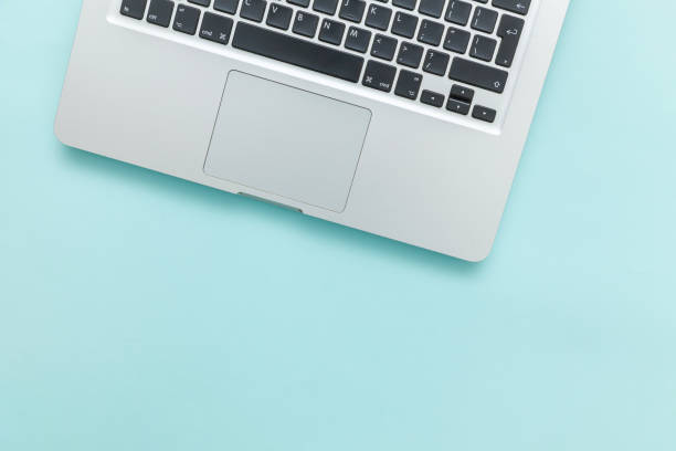 istock Keyboard laptop computer isolated on blue pastel desk background. Modern Information technology and sofware advances 1160281638