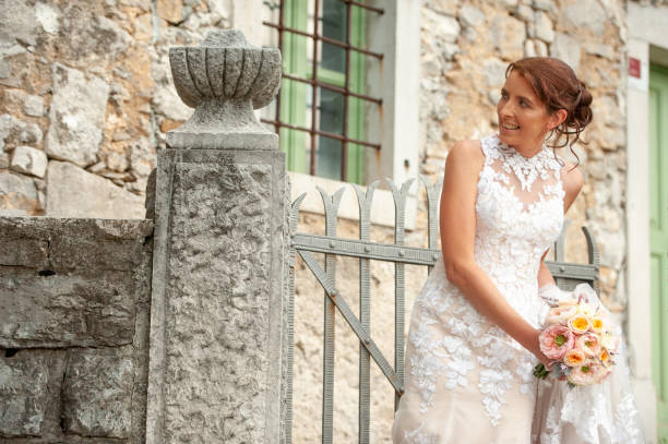 Smiling Bride in Wedding Dress Outdoors on Front Yard.