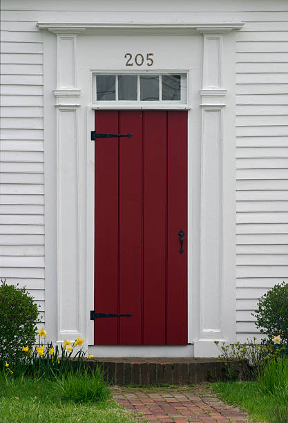 istock White Clapboard Home with Red Door, New England Architecture 116029544