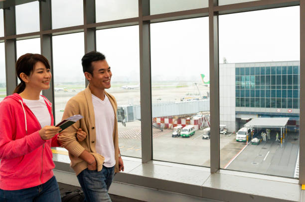 istock Happy couple walking at airport 1160296081
