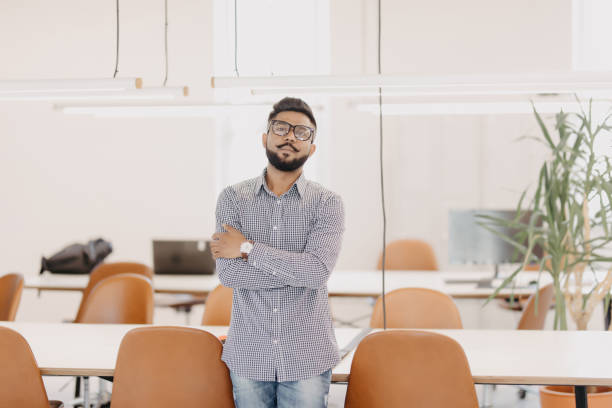 istock Young happy indian business man standing in modern office 1160296192