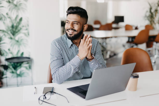 istock Young indian business man working on laptop in modern office 1160296234