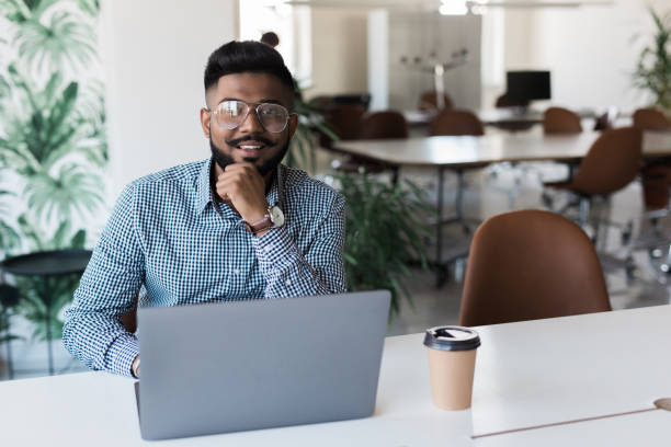 istock Young indian man smiling and working at modern office 1160296919