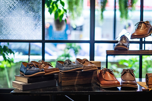 Retail display featuring a variety of high quality dress and casual shoes for men inside Taipei shoe store.