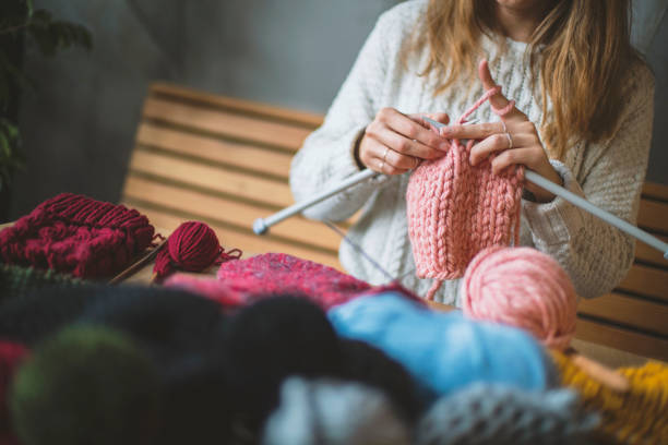 istock Close up on woman's hands knitting 1160297091