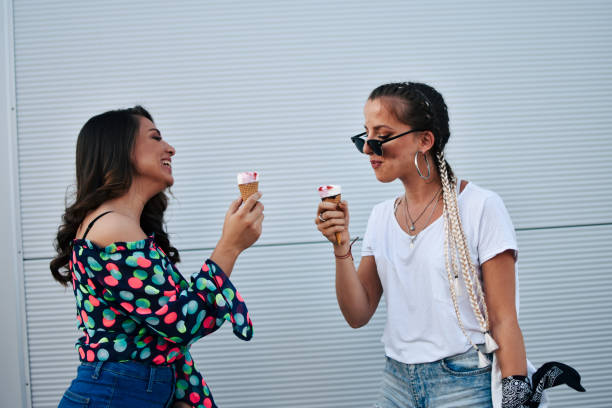 istock Beautiful women eating ice cream 1160297276