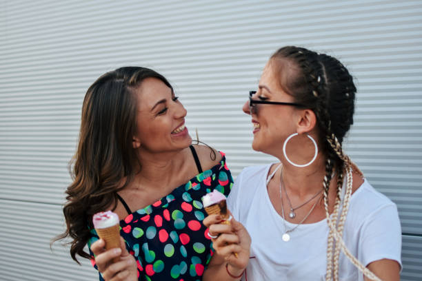 istock Beautiful women eating ice cream 1160301698
