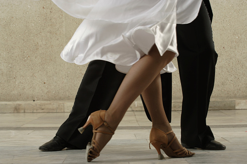 Young dancing pair in classical suits