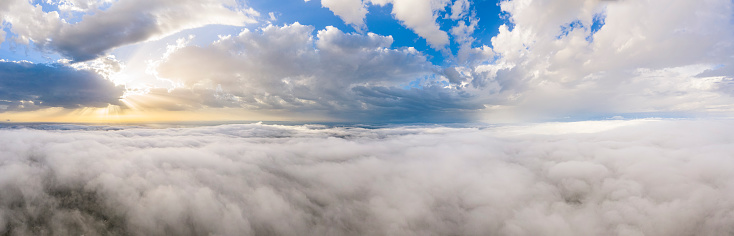 Above storm clouds with sunset