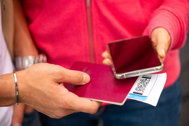 istock Couple holding mobile phone and boarding pass 1160318709