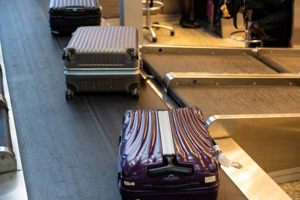 istock Luggage on conveyor belt at airport 1160318756