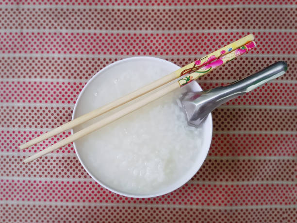 istock High Angle View of Hot Boiled Rice in Small Bowl with Chopstick on Top 1160319328