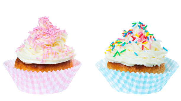 istock two cupcakes with whipped cream decorated sprinkles isolated on white background 1160319524