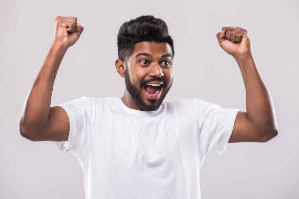 istock Happy young Indian man gesturing and smiling while standing against white background 1160326615