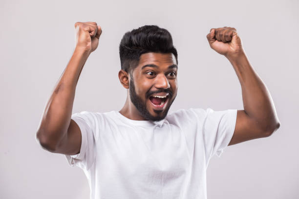 istock Happy young Indian man gesturing and smiling while standing against white background 1160326623