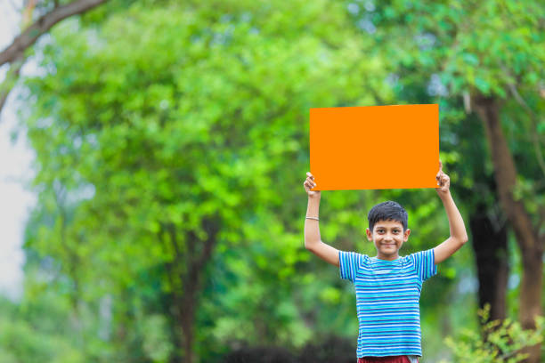 istock indian child holding poster 1160331597
