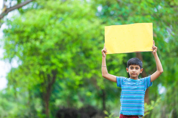 istock indian child holding poster 1160331605