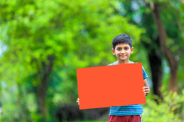 istock indian child holding poster 1160331612