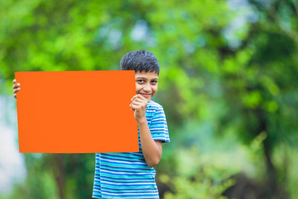 istock indian child holding poster 1160331685