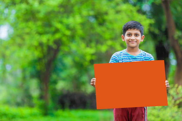 istock indian child holding poster 1160331689