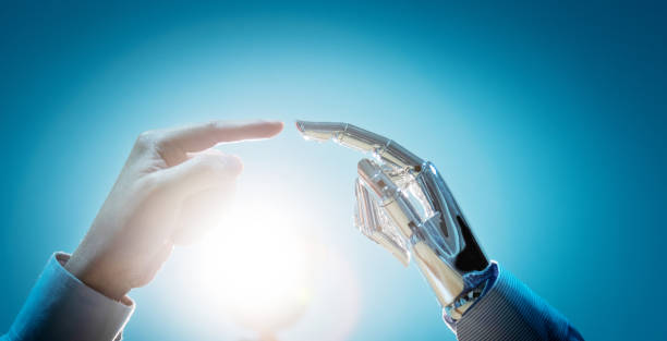 istock Businessman finger touching robot finger 1160331725