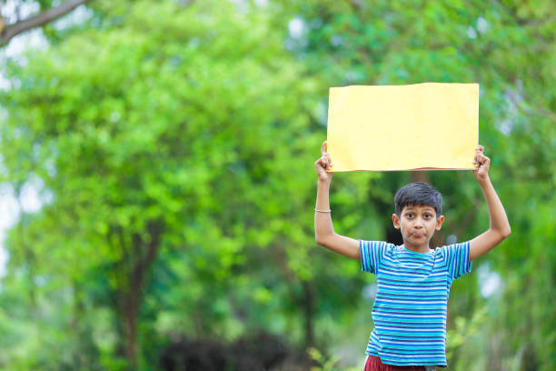 istock indian child holding poster 1160331744