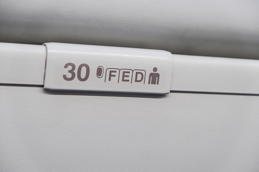 Seat numbers on luggage shells inside the passenger plane