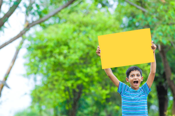 istock indian child holding poster 1160331842