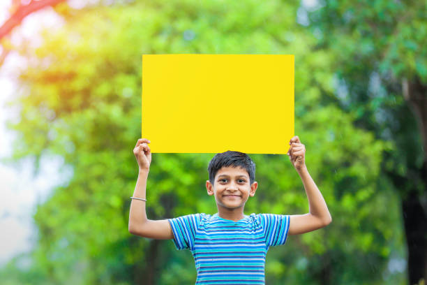 istock indian child holding poster 1160331856