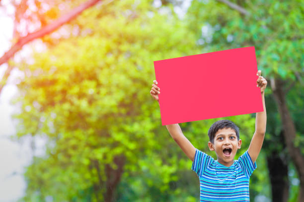 istock indian child holding poster 1160332531