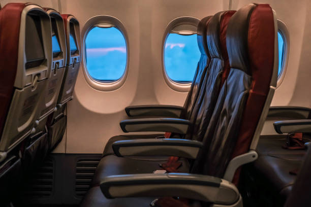 istock View of the sunset or sunrise sky and clouds from the plane window, empty seats. 1160332602