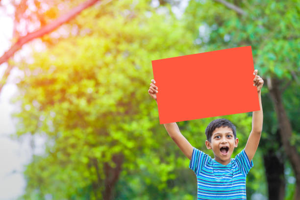 istock indian child holding poster 1160332652