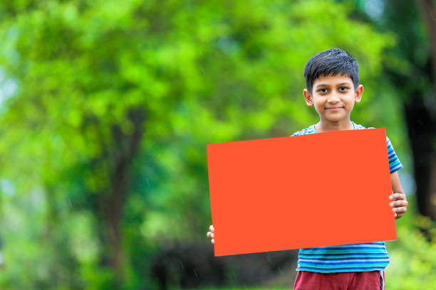 istock indian child holding poster 1160332656