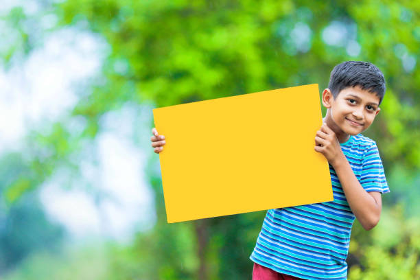 istock indian child holding poster 1160332698