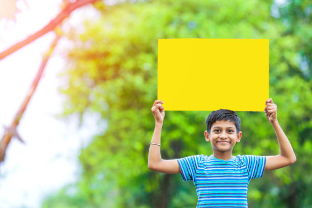 istock indian child holding poster 1160332700