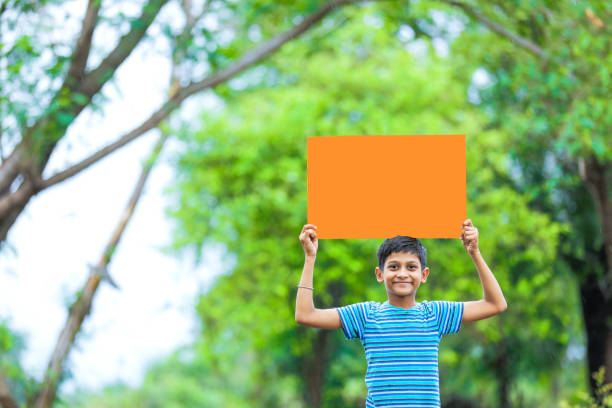 istock indian child holding poster 1160332949