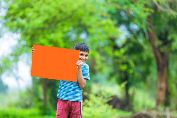 istock indian child holding poster 1160333035