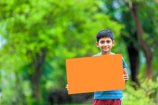 istock indian child holding poster 1160333037