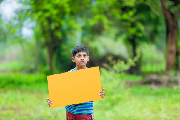 istock indian child holding poster 1160333116