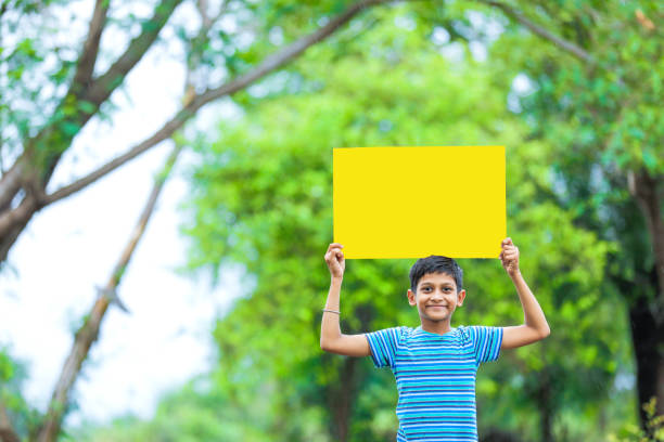 istock indian child holding poster 1160333142