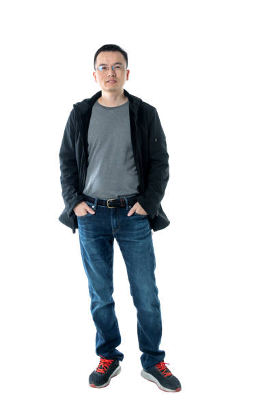 istock Man standing with hands in pockets on white background 1160334181
