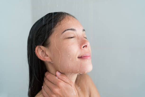 Shower woman showering relaxing washing face Shower woman showering relaxing under water massaging neck in hot shower. Asian female adult face enjoying spa relaxation time relaxing meditating in warm bath cleaning face and body at home. woman hot shower stock pictures, royalty-free photos & images