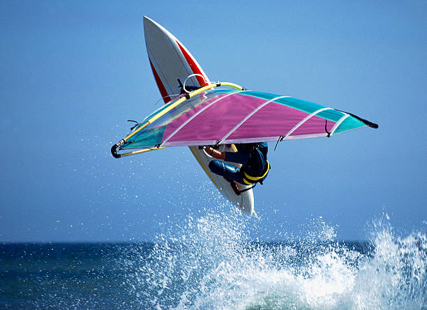 Wave-Jumping windsurfer. stock photo