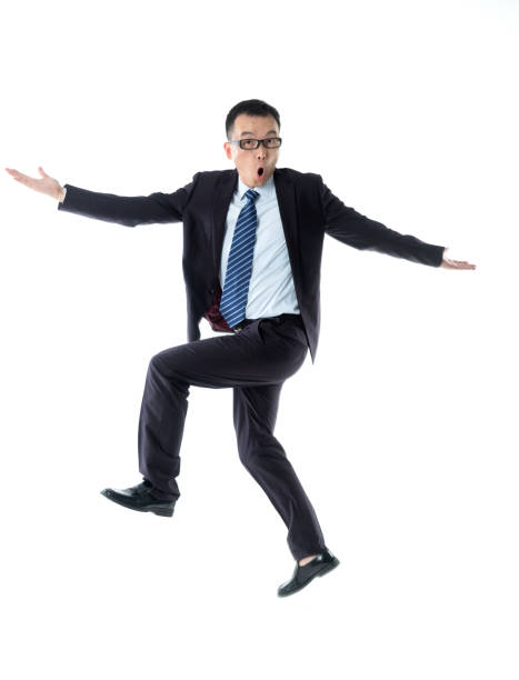 Cheerful businessman dancing on white background.