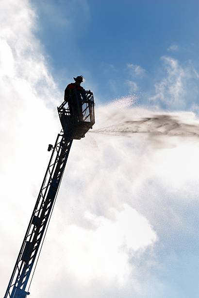 firefighter Firefighter on a high ladder. ladder photos stock pictures, royalty-free photos & images