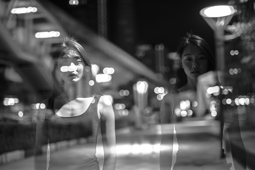Portrait Of Beautiful Young Chinese Woman Outdoors At Night