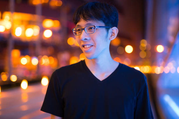 istock Happy Asian Man Thinking Outdoors At Night 1160336881