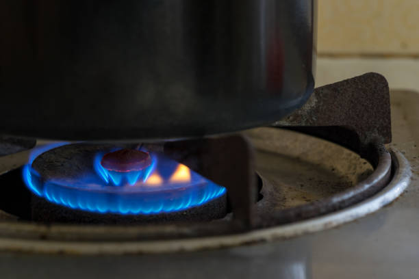 blue fire frame on cooking pot on old gas oven in kitchen for safety concept
