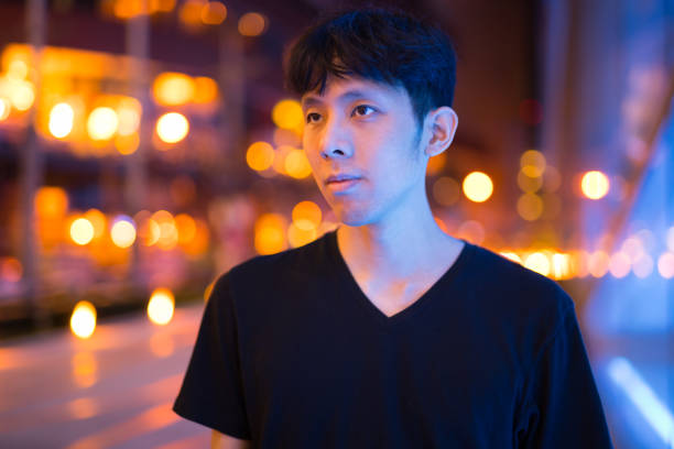 istock Portrait Of Asian Man Thinking Outdoors At Night 1160337977