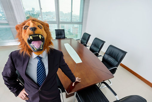 Businessman wearing a mask in board room.